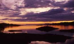 a dramatic sunset on the Small isles of Rum and Eigg,  looking from Loch Ailort